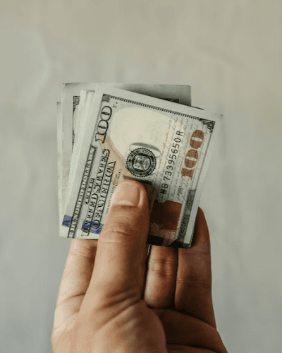 A person holding a stack of money