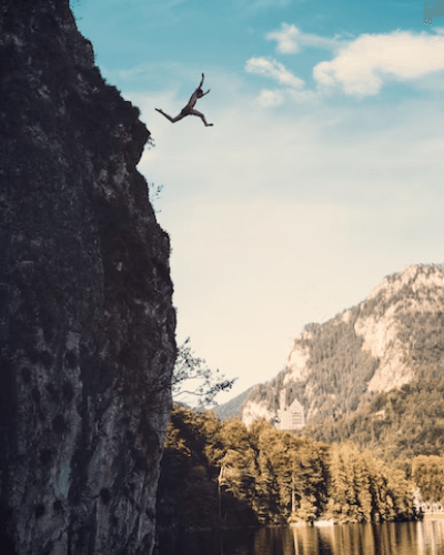 person jumping off a cliff
