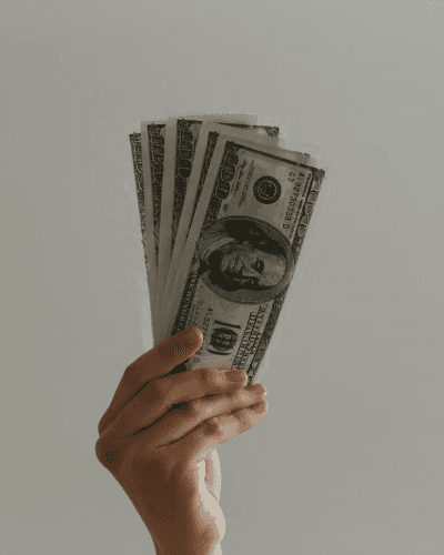 Person holding hundreds of dollars
