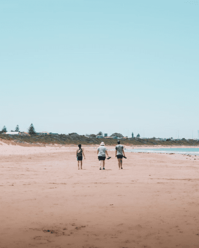 people walking along the beach