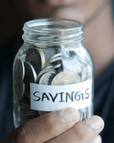 person holding a jar labeled savings